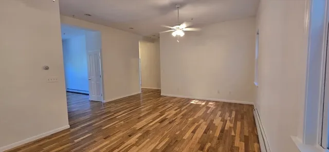 wooden floor in an empty room with a window