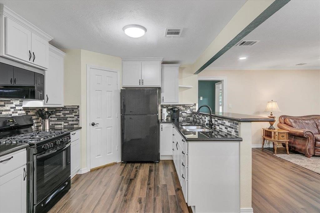 3702 Travis Drive Beaumont, TX 77708 - Photo 11 of 28 a kitchen with stainless steel appliances a stove refrigerator sink and microwave
