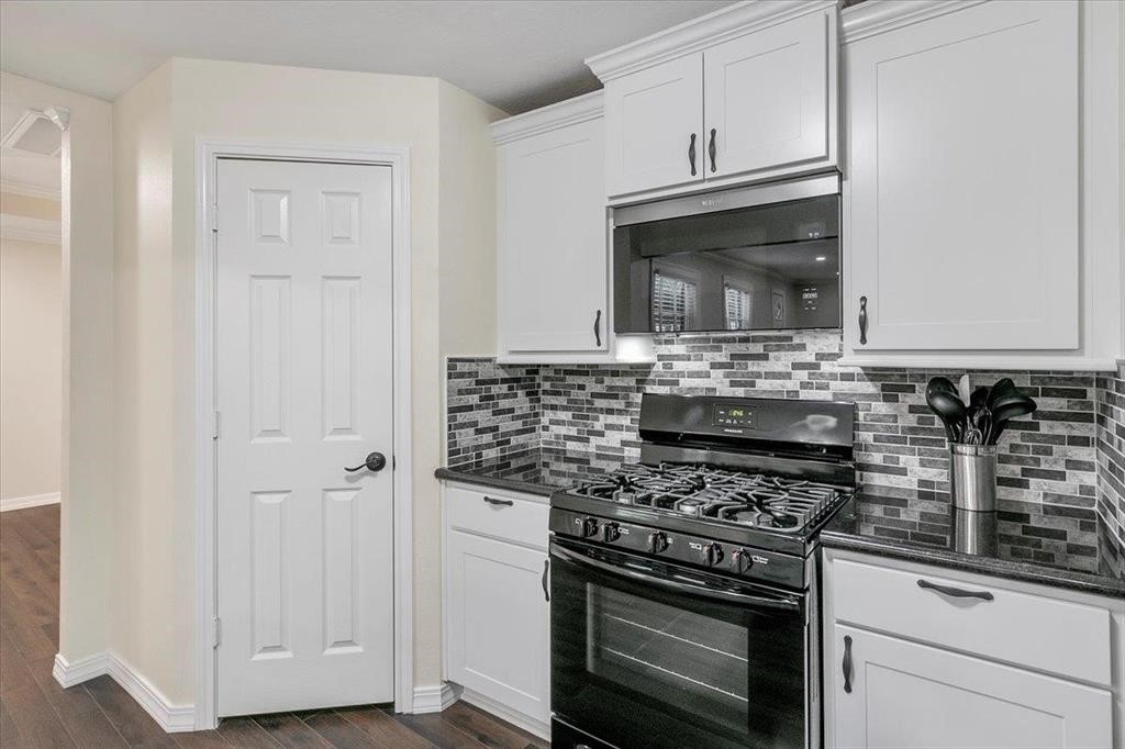 3702 Travis Drive Beaumont, TX 77708 - Photo 14 of 28 a kitchen with cabinets and stainless steel appliances