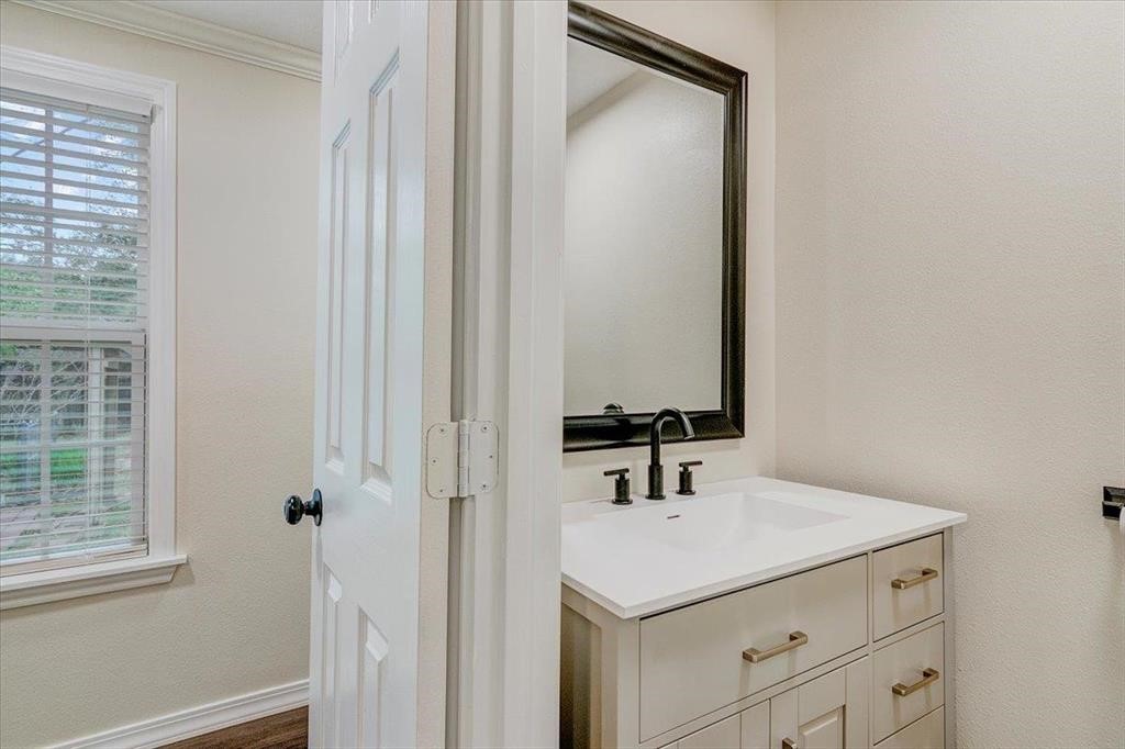 3702 Travis Drive Beaumont, TX 77708 - Photo 17 of 28 a bathroom with a sink and a mirror