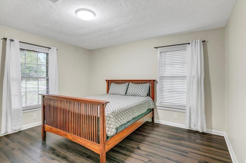 3702 Travis Drive Beaumont, TX 77708 - Photo 18 of 28 a bed sitting in a bedroom next to a window