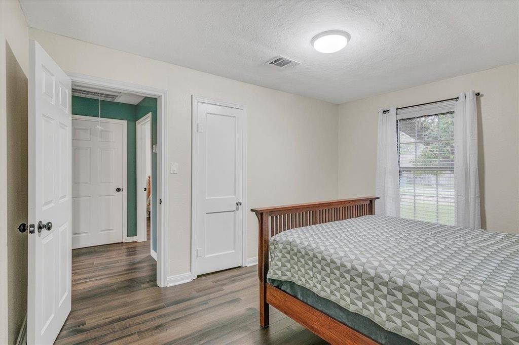 3702 Travis Drive Beaumont, TX 77708 - Photo 19 of 28 a bedroom with a bed and wooden floor