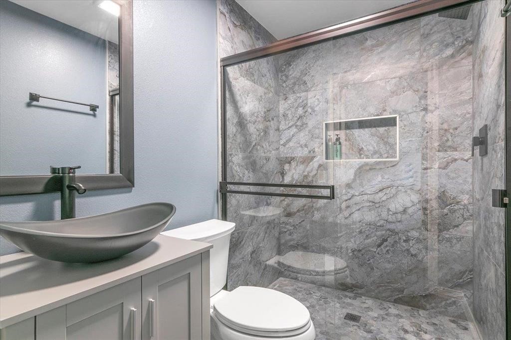 3702 Travis Drive Beaumont, TX 77708 - Photo 20 of 28 a bathroom with a toilet a sink and shower