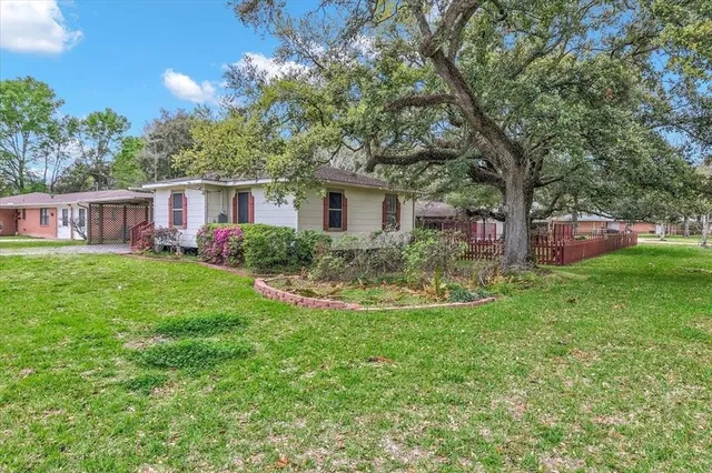 a view of a house with a backyard and a patio