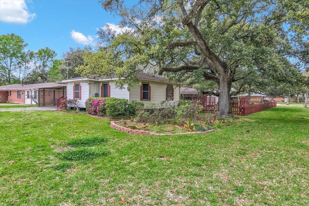 3702 Travis Drive Beaumont, TX 77708 - Photo 4 of 28 a view of a house with a backyard and a patio