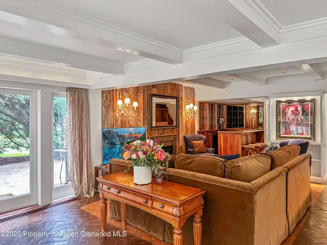 a living room with furniture and a floor to ceiling window
