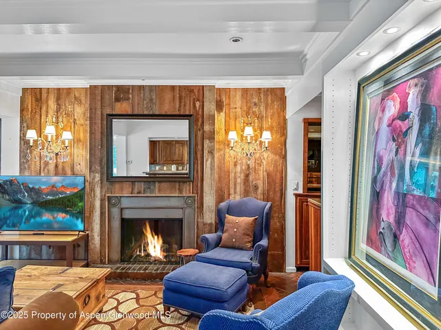 a living room with furniture fireplace and flat screen tv
