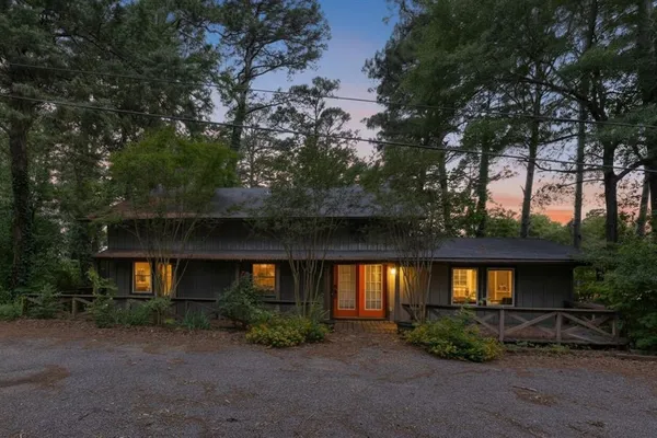 a front view of a house with lots of green space