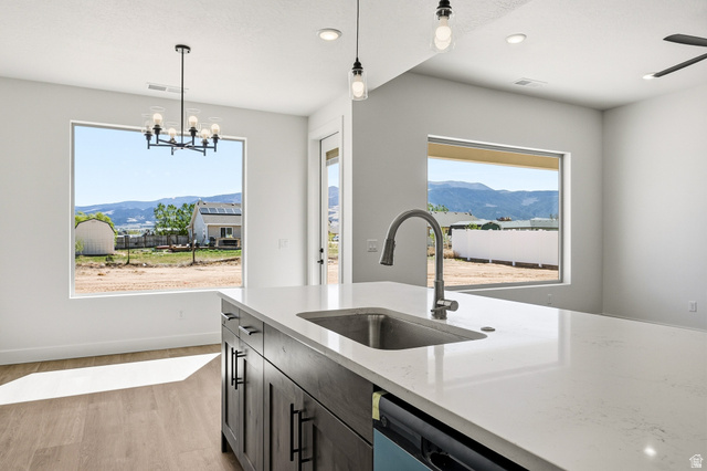 4978 North 75 East Enoch, UT 84721 - Photo 14 of 60 Kitchen featuring a mountain view, light wood finished floors, light stone countertops, and suspended lighting