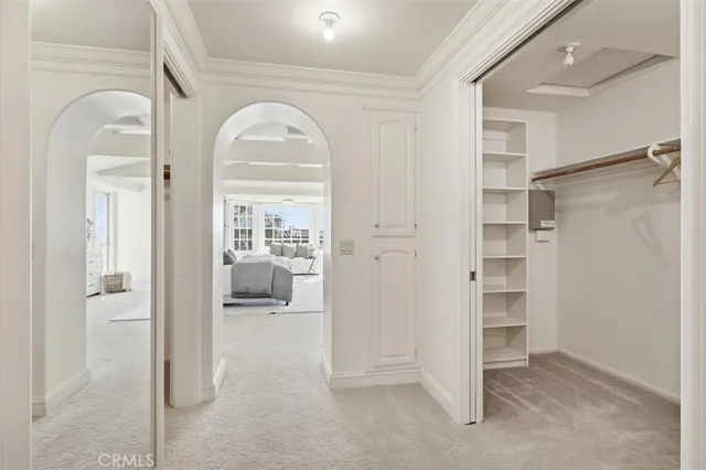 a large kitchen with a sink and living room view