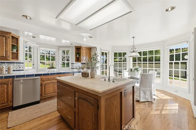 a kitchen with stainless steel appliances granite countertop a sink and a stove