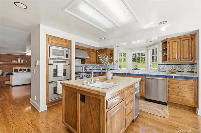 a view of a dining room with furniture a chandelier and wooden floor