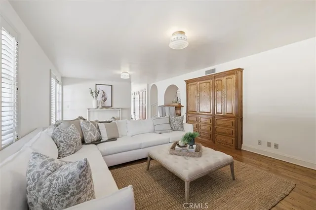 a view of a livingroom with wooden floor and a window