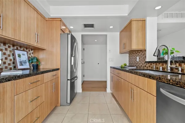a kitchen with granite countertop a sink and cabinets