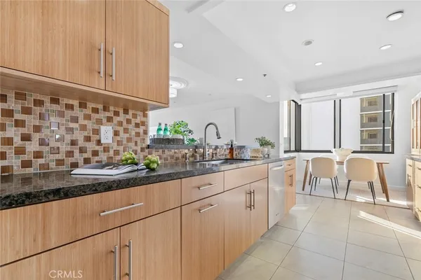 an open kitchen with stainless steel appliances granite countertop a refrigerator and a sink