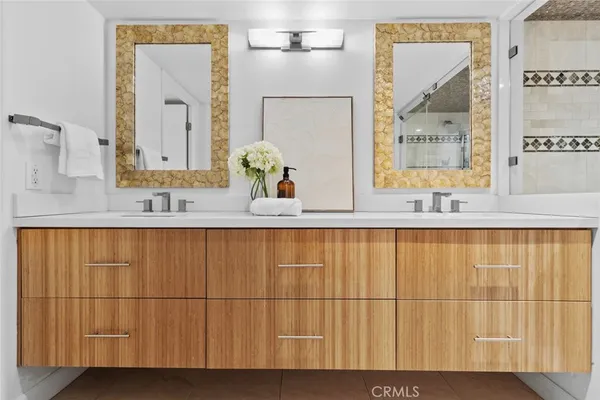 a bathroom with a double vanity sink and mirror