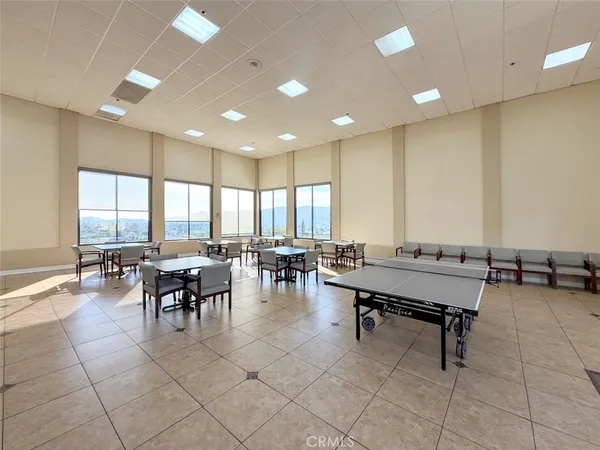 a view of a living room with a table and chairs