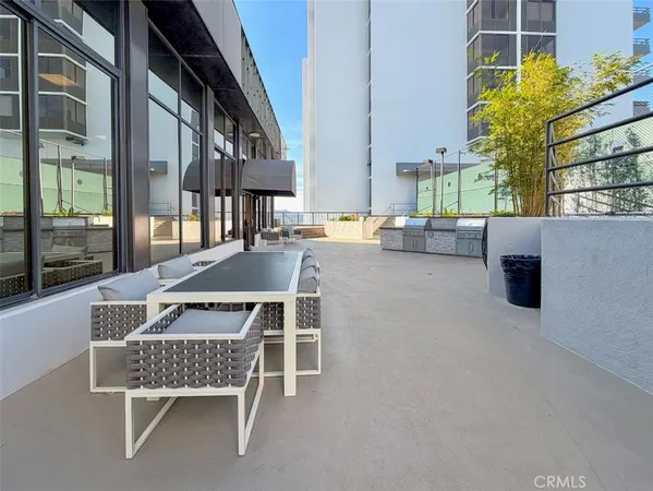 a roof deck with outdoor seating and city view
