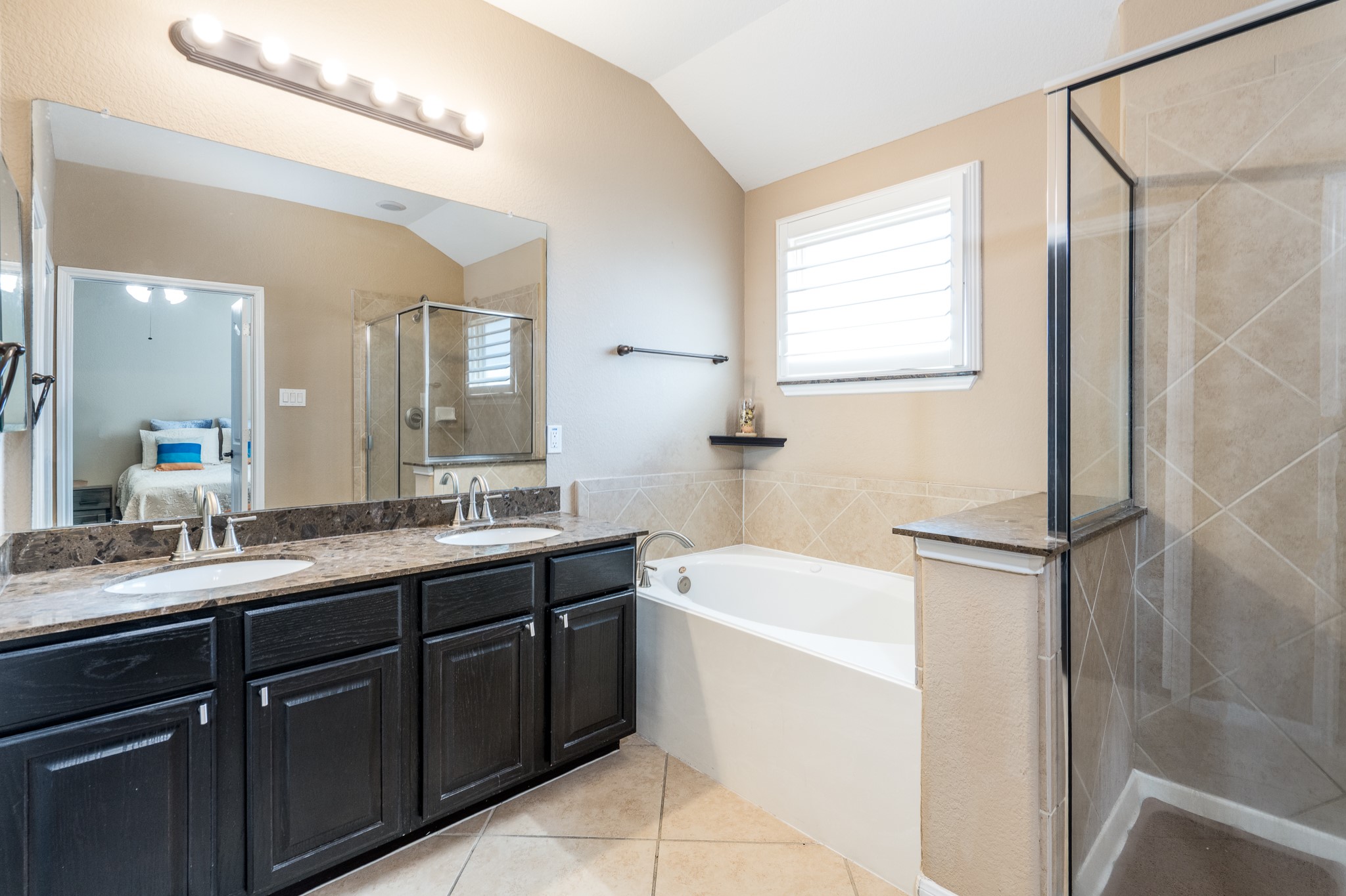 9115 Monarch Mist Lane Houston, TX 77070 - Photo 17 of 26 a bathroom with a tub sink and mirror