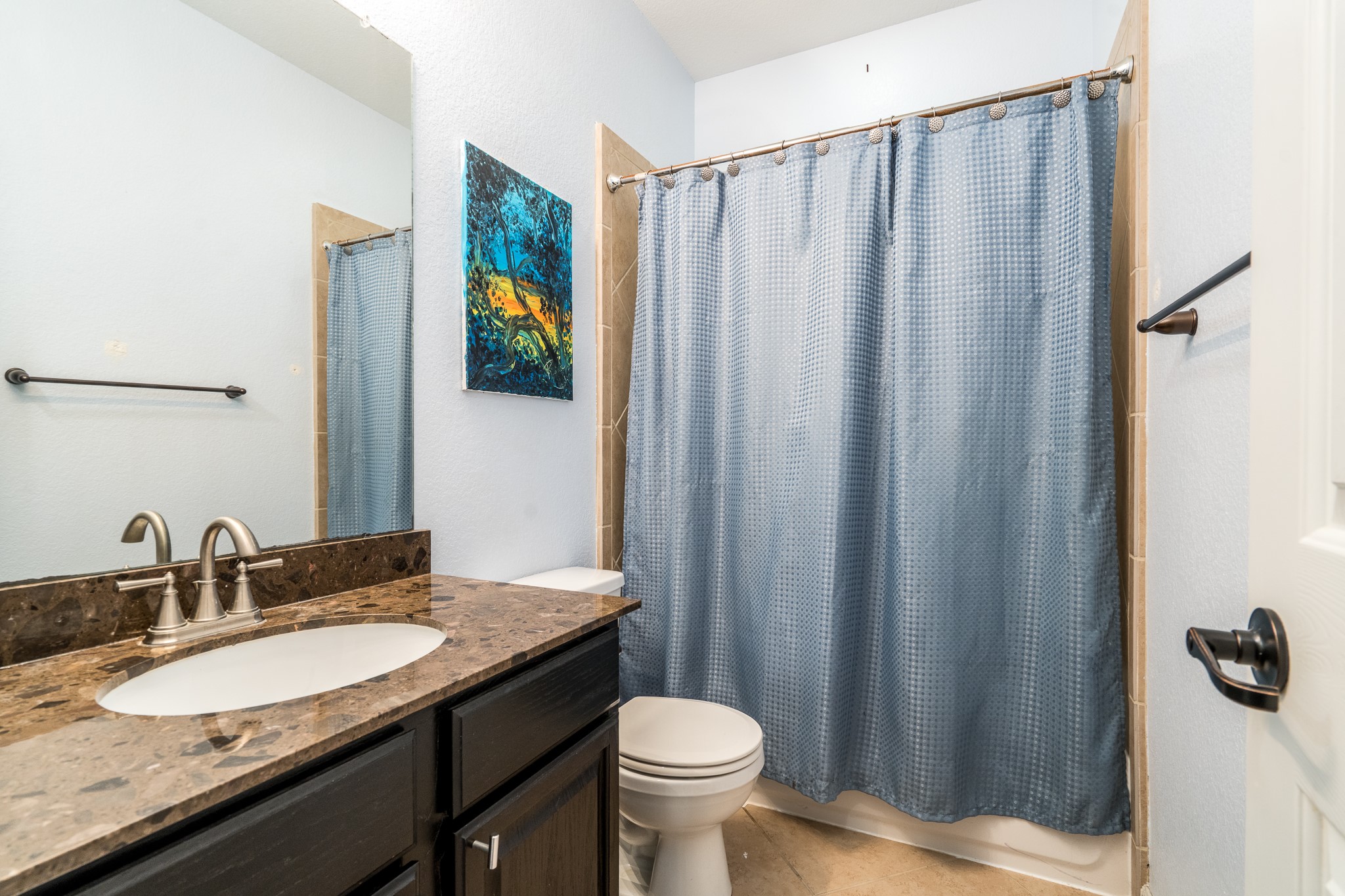 9115 Monarch Mist Lane Houston, TX 77070 - Photo 20 of 26 a bathroom with a granite countertop sink and a mirror