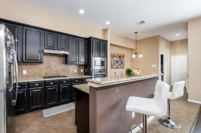 a kitchen with stainless steel appliances granite countertop a sink and stove