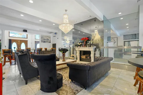 a living room with furniture a fireplace and kitchen view