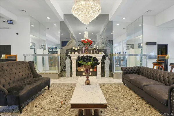 a living room with furniture and a chandelier