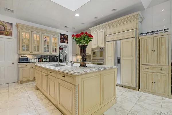 a kitchen with kitchen island granite countertop cabinets and refrigerator
