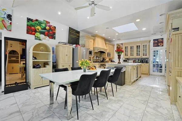 a kitchen with stainless steel appliances granite countertop a sink a stove and a refrigerator