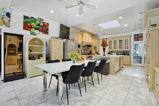 a kitchen with stainless steel appliances granite countertop a sink a stove and a refrigerator