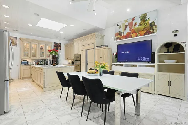 a large kitchen with a table and chairs