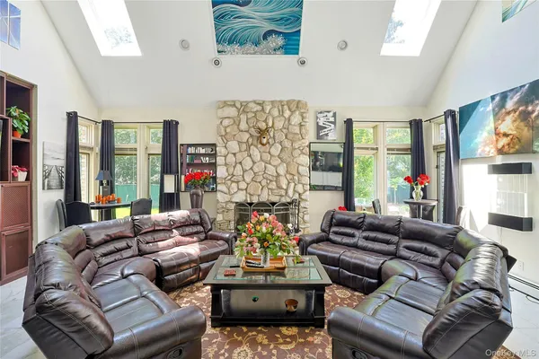 a living room with fireplace furniture and a large window