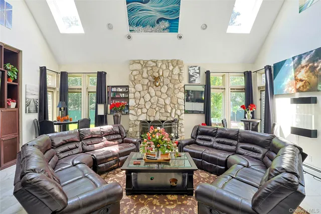 a living room with fireplace furniture and a large window
