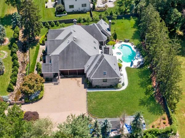 an aerial view of a house with a yard basket ball court and outdoor seating