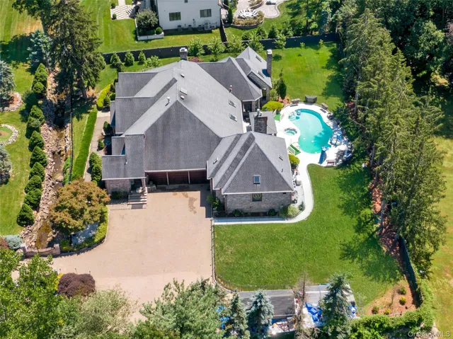 an aerial view of a house with a yard basket ball court and outdoor seating