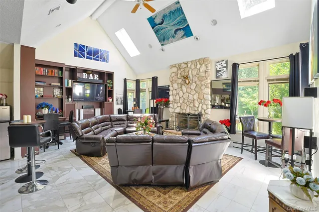 a view of a livingroom with workspace and a couch