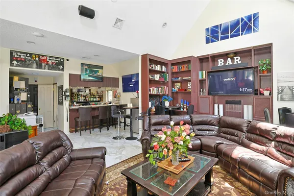 a living room with furniture and a book shelf