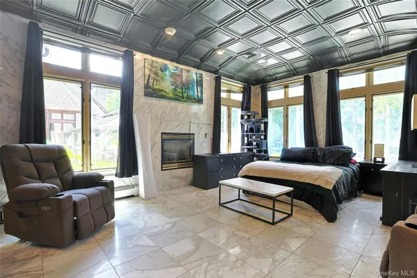 a bedroom with a bed and a large window