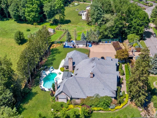 an aerial view of a house with yard swimming pool and outdoor seating