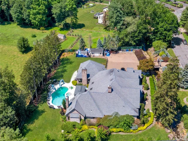 an aerial view of a house with yard swimming pool and outdoor seating