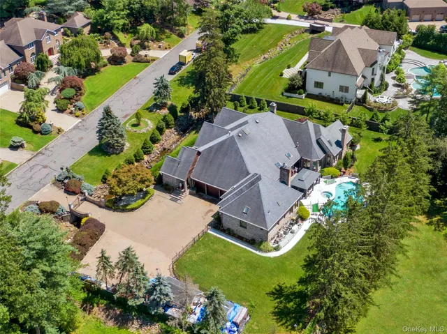 a aerial view of a house with yard and green space