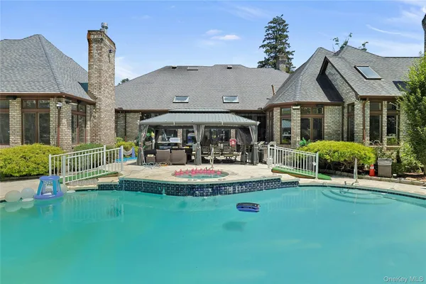 a view of house with a big yard and potted plants