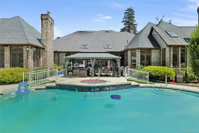 a view of house with a big yard and potted plants