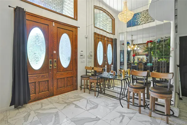 a room with furniture a mirror and a clock on walls