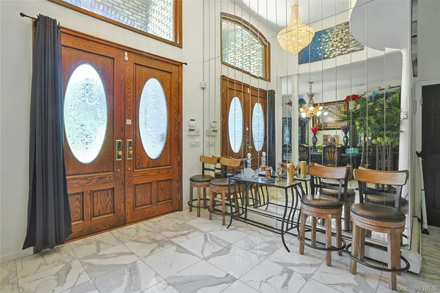 a room with furniture a mirror and a clock on walls