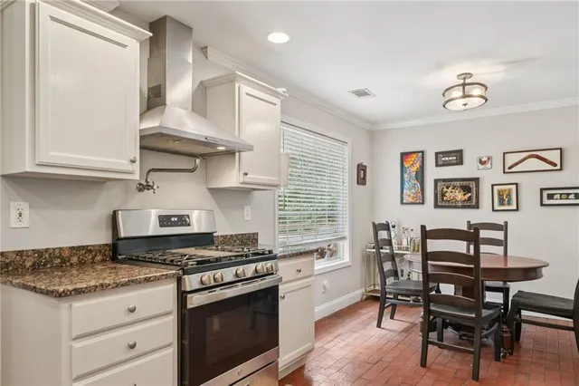 a kitchen with stainless steel appliances granite countertop a stove and a refrigerator
