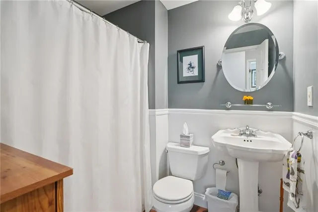 a bathroom with a sink a mirror and a toilet