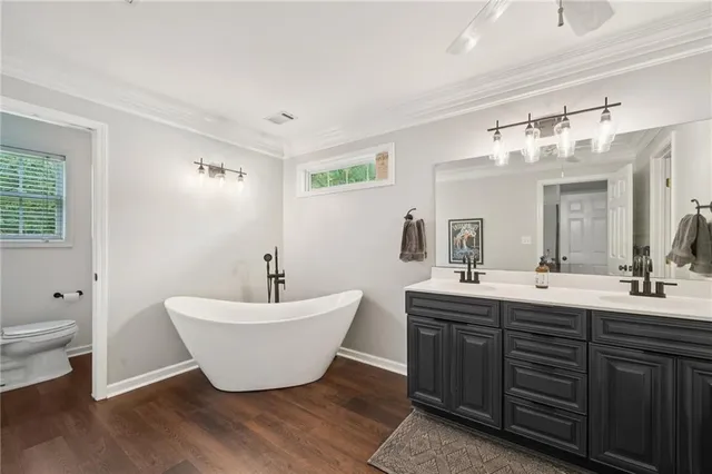 a spacious bathroom with a double vanity sink mirror and toilet