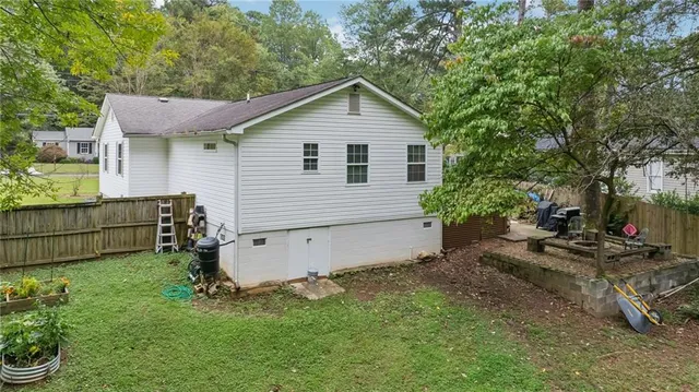 a view of a backyard with plants and a garden