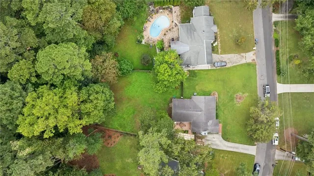 an aerial view of a house with a yard and lake view
